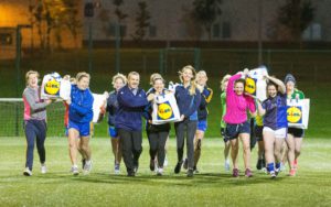 Kieran McManus , Store Manager and Karolina Tamosaityte Lidl Ennis Ladies Football Chairperson  Bernie Regan and Clare Lady Footballers with some the Lidl food bags after training this week. Photograph by Eamon Ward